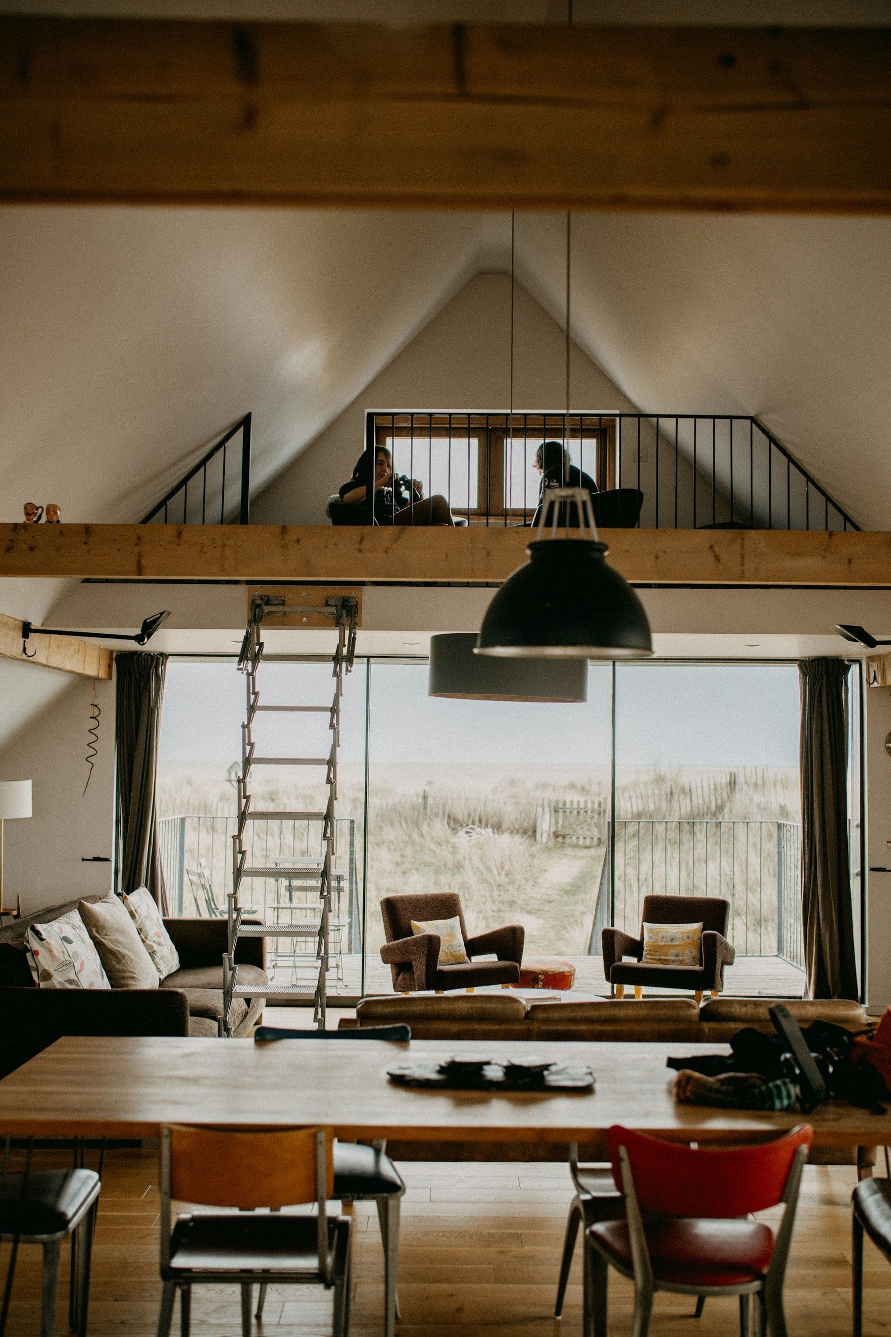 Illustrative image: living room with a loft and a large window