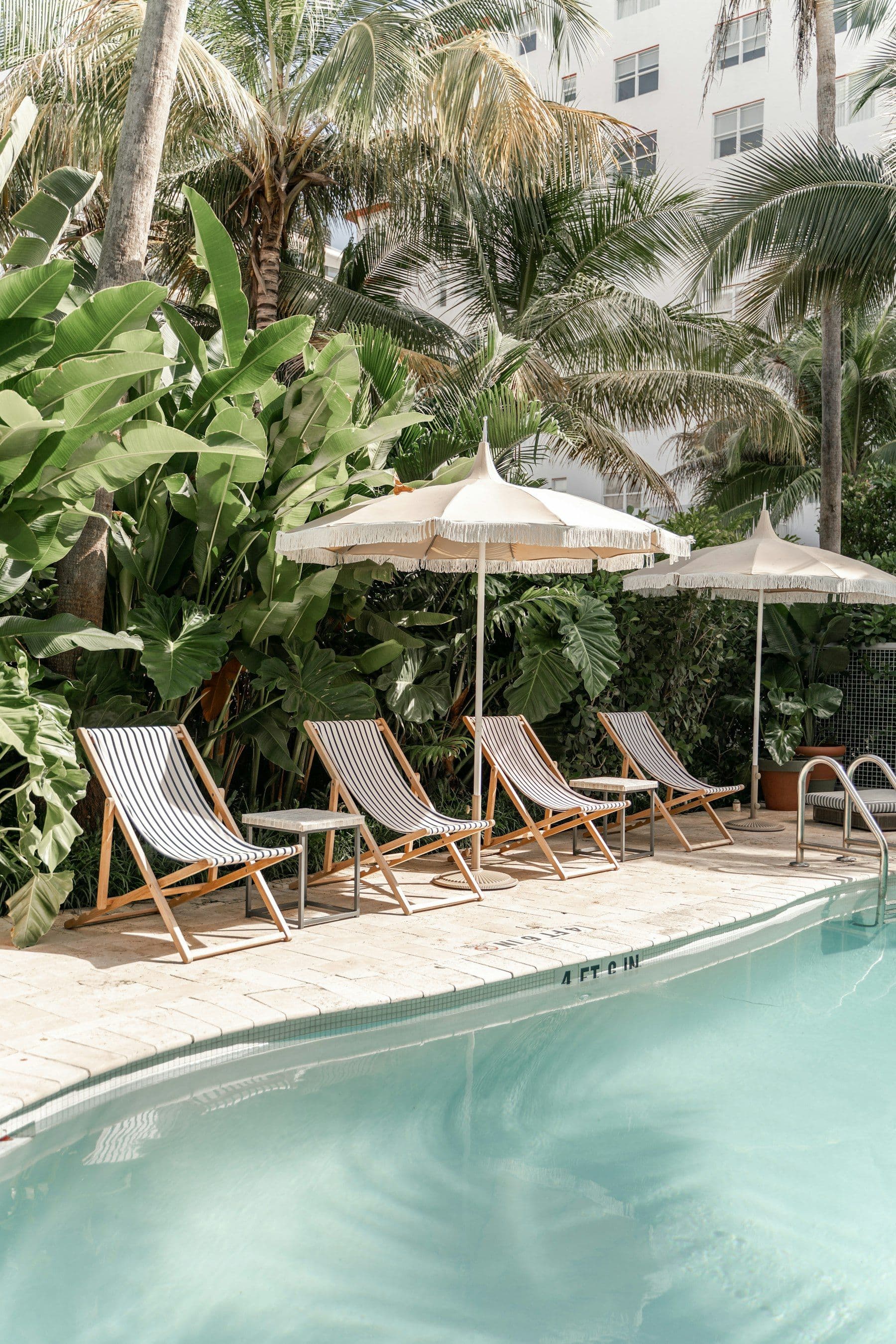 Illustrative image: deck chairs beside a shared pool